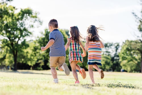 Preview: Three little friends running together in the park.