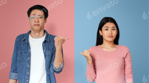 Preview: Asian couple pointing at each other with expression of disgust
