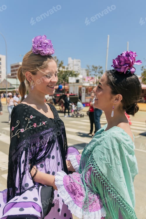 Preview: Cheerful women in traditional flamenco clothes during festival