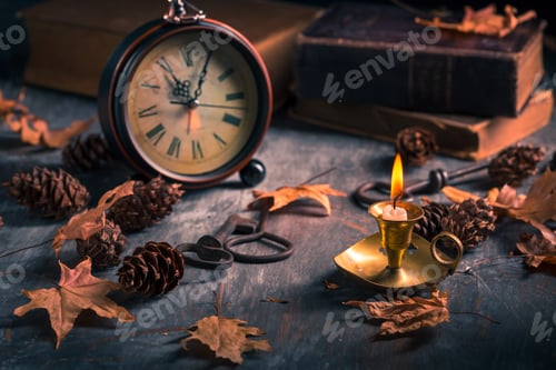 Preview: Vintage still life with antique books, clock and candle. Halloween and occult concept.