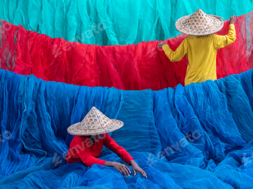 Preview: Two unidentified fishermen arranging fishnets.