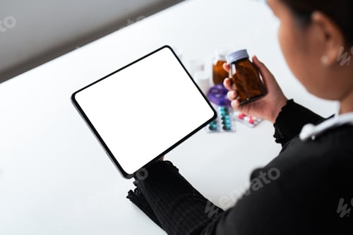 Preview: Woman hold bottle of drug smartphon painkiller or vitamin supplement reading label ready to