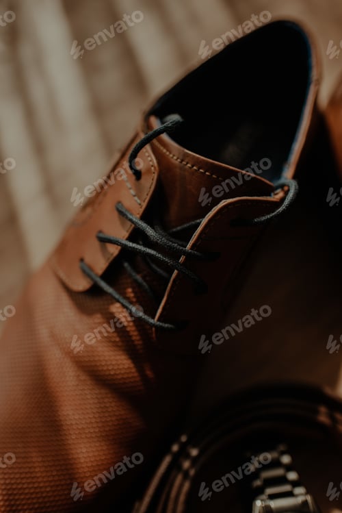 Preview: Vertical shot of elegant brown shoes of the groom