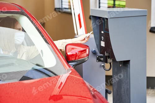 Preview: Woman getting ticket from parking meter in underground parking