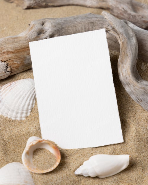 Preview: Mockup of blank card on beige sand with seashells, template for beach wedding and event graphics