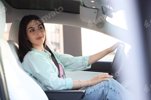 Preview: Woman holding steering wheel while driving car, view from outside