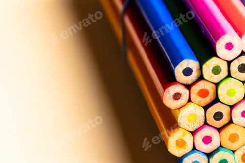Preview: Close up of multi coloured pencils and copy space on orange background