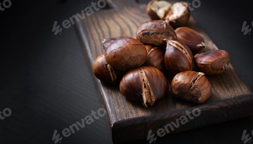 Preview: Roasted chestnuts on dark wooden background
