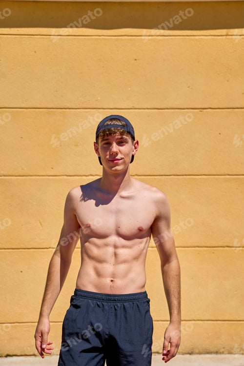 Preview: Young male athlete in cap posing outdoors