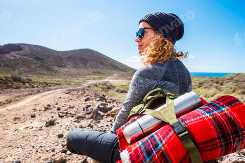 Preview: People and trekking backpack travel adventure activity - blonde woman sit down and rest