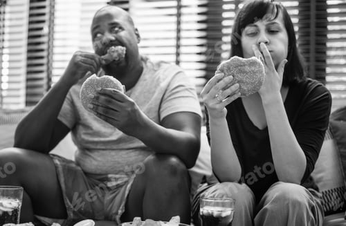 Preview: Couple having fast food on the couch