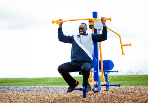 Preview: young man working out at outdoor gym