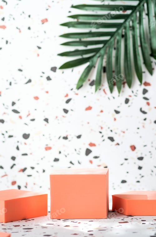 Preview: peach geometric pedestal on terrazzo background with summer sunlight and green palm leaf
