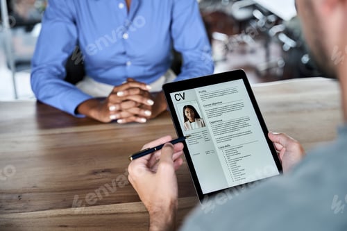 Preview: Close up over shoulder view of professional male HR manager checking digital cv.