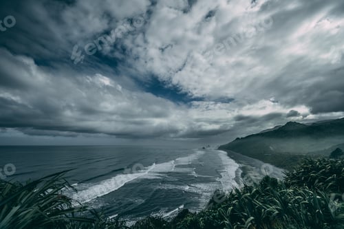 Preview: Gloomy scenery of ocean waves moving towards the shore under the cloudy sky