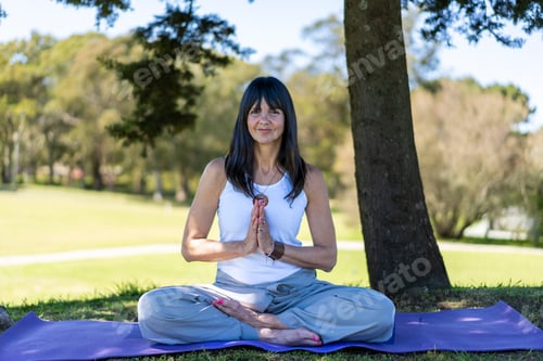 Preview: Woman Meditating Outdoors in a Peaceful City Park