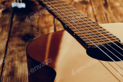 Preview: Wooden acoustic guitar body and fingerboard close up