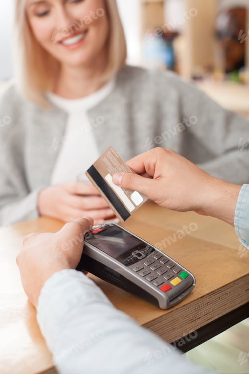 Preview: Close Up Of Hands Of Barista Serving Female Customer. The Woman Is Paying For Her Order With Credit