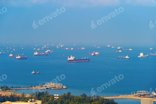 Preview: Cargo tanker ships in transportation concept. Shipping boats at Singapore harbor. Clear blue sea.