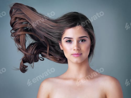 Preview: Studio shot of a beautiful young woman posing against a gray background