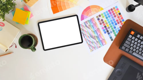 Preview: Flat lay of a graphic designer desk featuring a digital tablet with blank screen