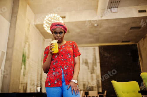 Preview: Stylish african woman in red shirt and hat