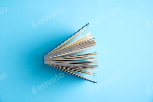 Preview: Hardcover book on light blue background, top view