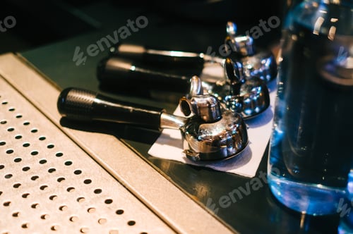 Preview: Holders from coffee machine for brewing coffee on bar counter table, close up.