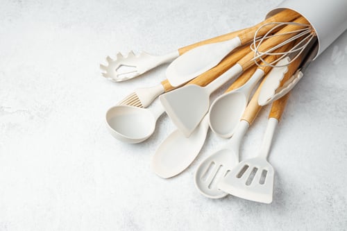 Preview: Kitchen utensils arranged neatly in a container on a light surface