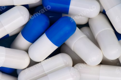 Preview: Close-up Heap of medical pills in white and blue colors.