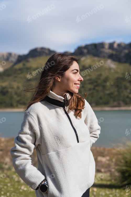 Preview: Woman enjoying scenic mountain lake view