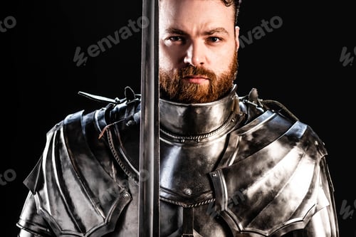 Preview: handsome knight in armor holding sword isolated on black