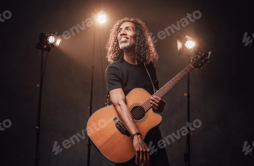 Preview: Adult Male Performing with Acoustic Guitar on Stage