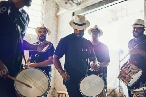 Preview: Play it to the beat. Shot of a group of musical performers playing drums together.