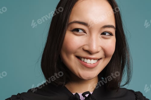Preview: Young asian woman wearing collar smiling and looking aside