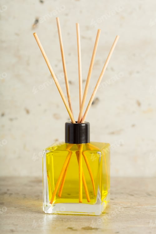 Preview: Decorative yellow fragrance diffuser with reeds on a minimalist surface
