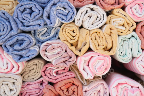 Preview: Discover a wide array of Colorful Rolled Fabrics featuring Various Textures and Unique Patterns