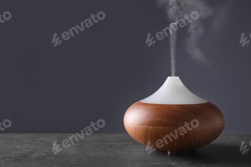 Preview: Aroma oil diffuser on table against color background