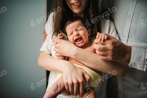 Preview: Crop parents comforting crying baby