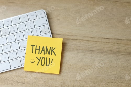 Preview: Handwritten Thank You On Yellow Sticky Note With White Keyboard