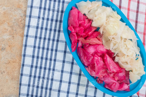 Preview: Red and white fermented cabbage on blue plate