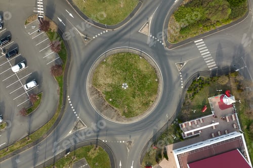 Preview: Aerial view of road roundabout intersection with fast moving heavy traffic.