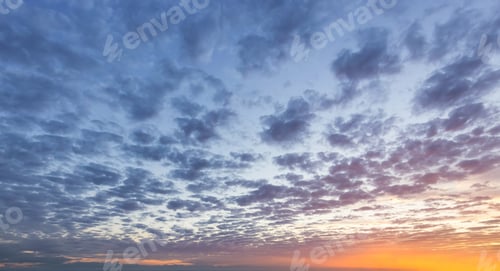 Preview: View of colorful cloudscape during dramatic sunset on the ocean coast