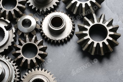 Preview: Different stainless steel gears on light grey background, above view