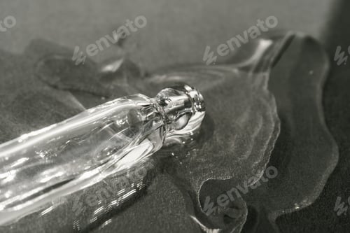 Preview: The texture of serum or oil with a pipette on a beige background.
