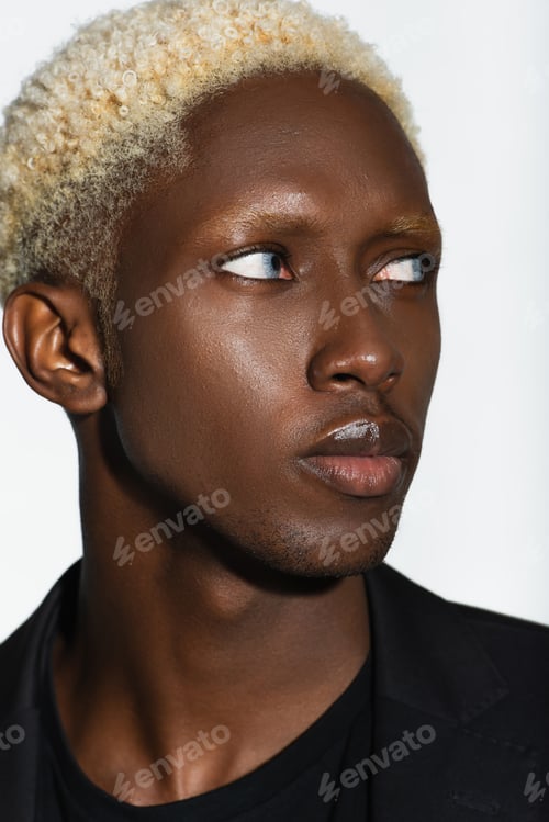 Preview: close up portrait of young african american man with blonde hair isolated on grey