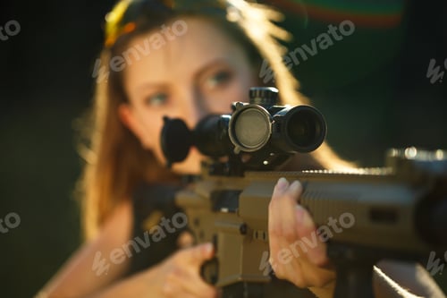 Preview: Girl with a gun for trap shooting aiming at a target