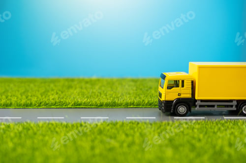 Preview: A truck drives along a country road through green meadows.