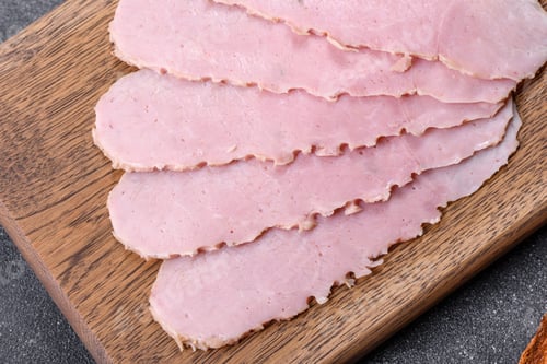 Preview: Sliced ham on wooden background. Fresh prosciutto. Pork ham sliced