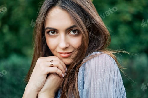 Preview: Young beautiful woman outdoors on green background summer nature